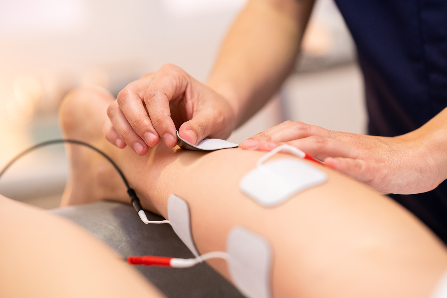 Electro stimulation in physical therapy to a young woman