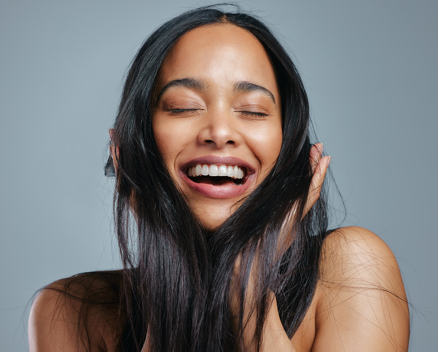 Happy woman touching her hair