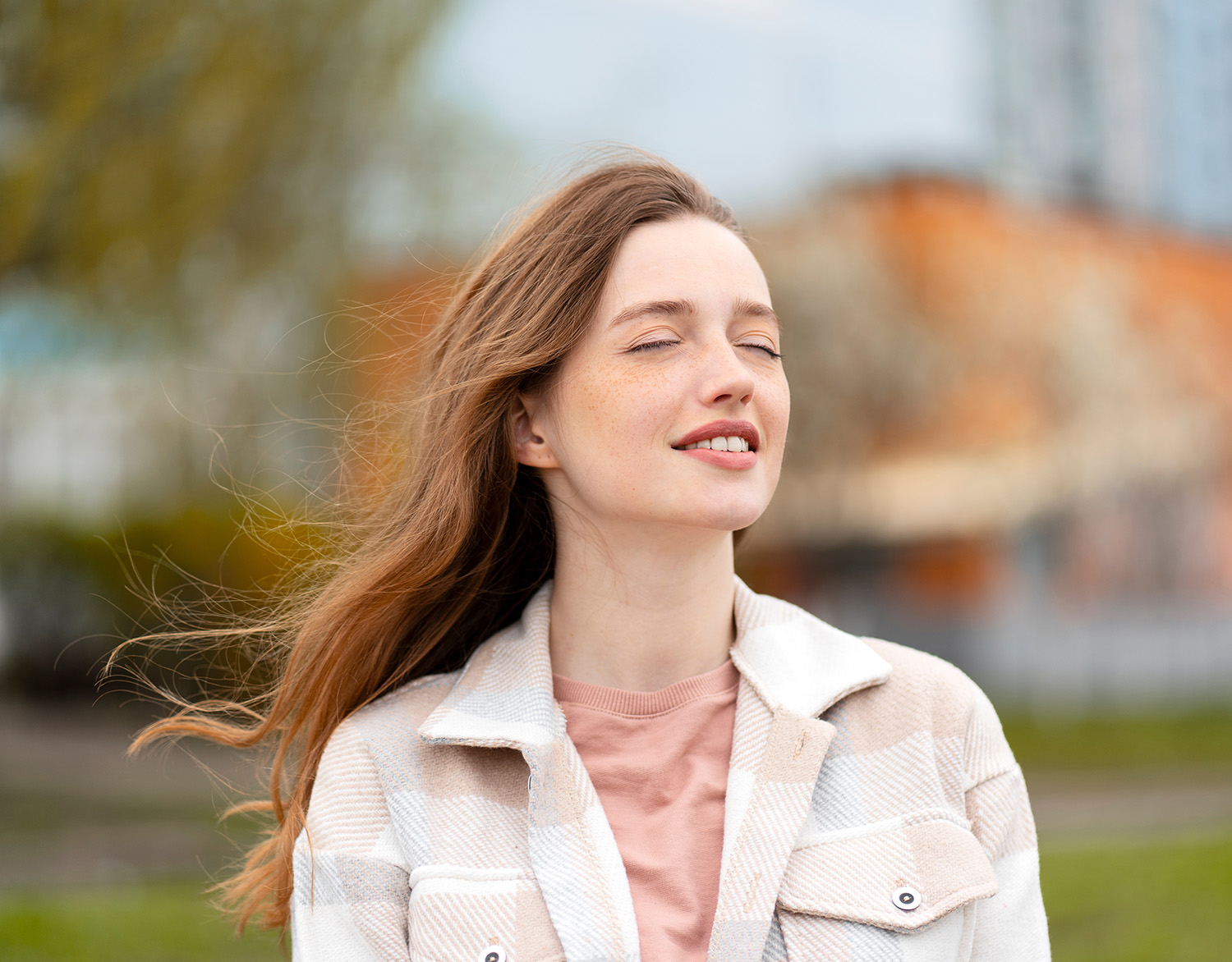 Portrait of young beautiful smiling woman with cute freckles